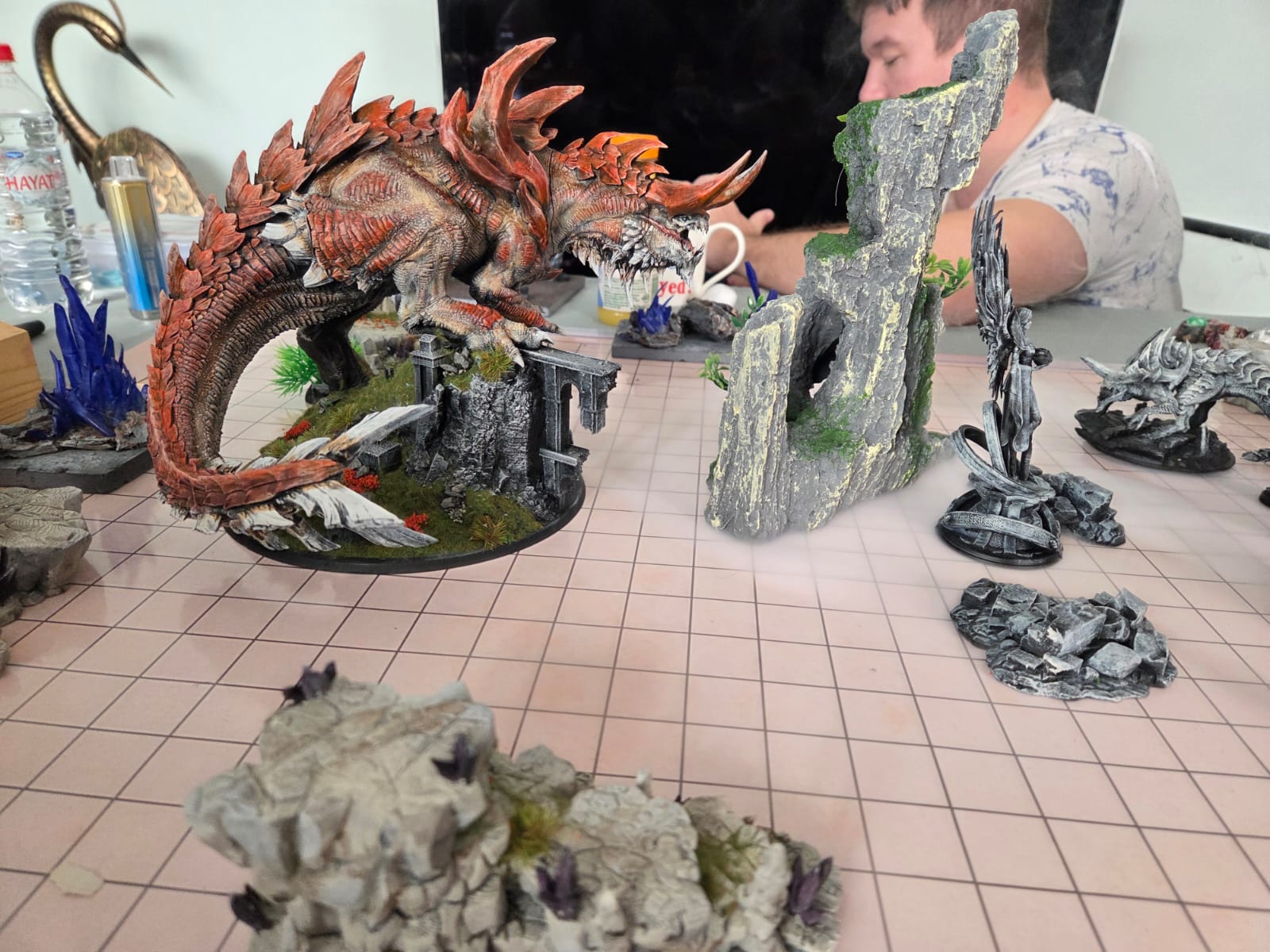 A red dragon miniature mid-game
